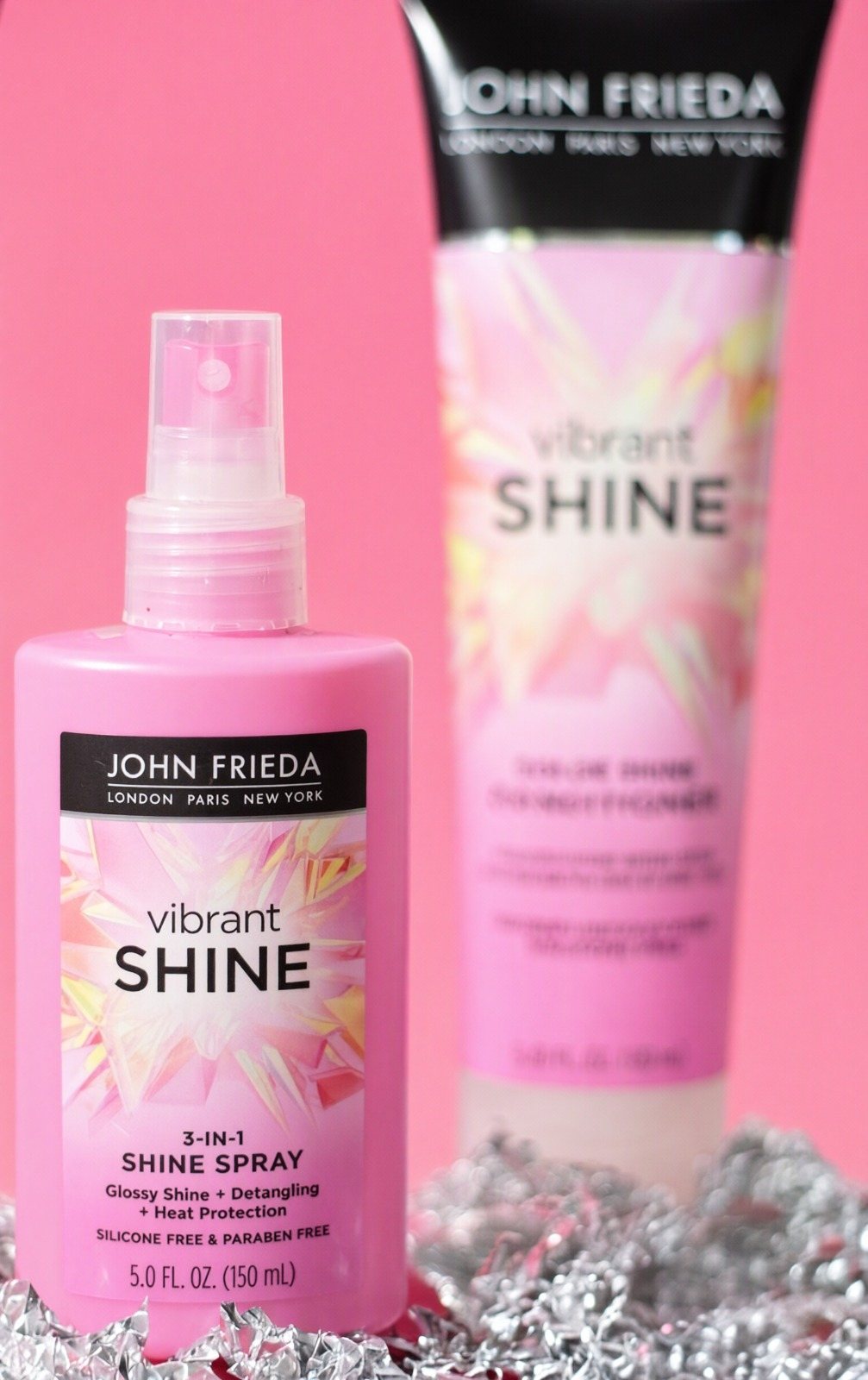 Productos para el cabello en botellas rosadas sobre fondo rosa